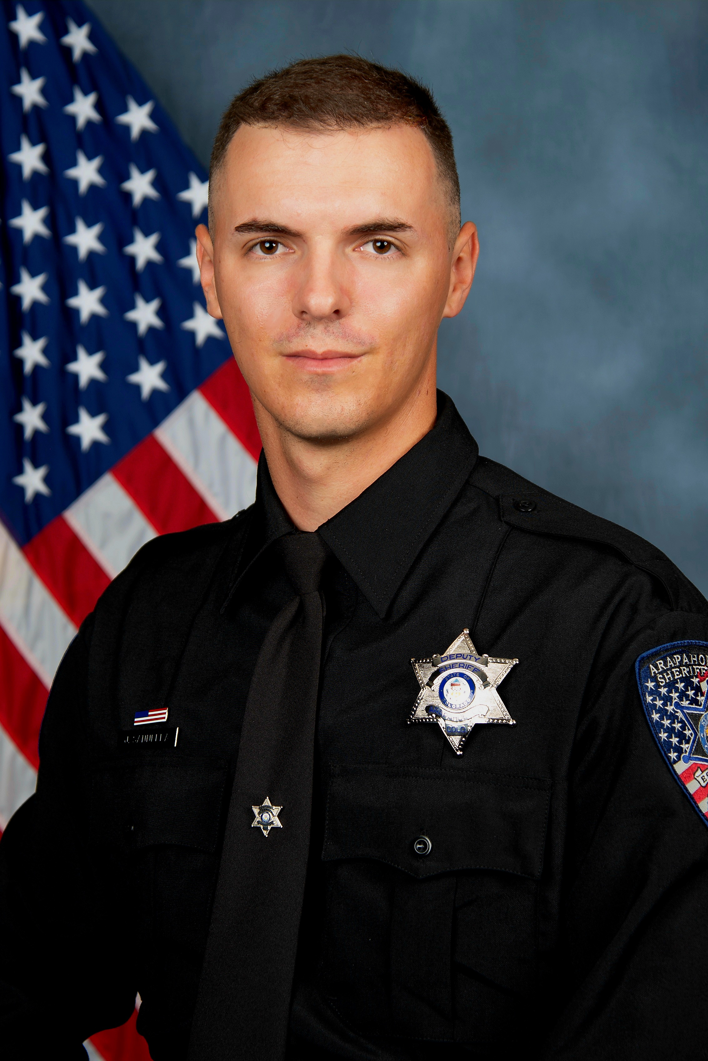 Jordi Enric Sannella in law enforcement uniform